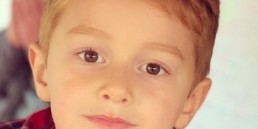 5-year-old model in tee and red flannel