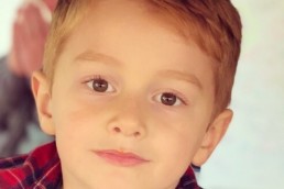 5-year-old model in tee and red flannel