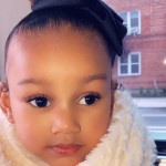 headshot of child model in cream scarf